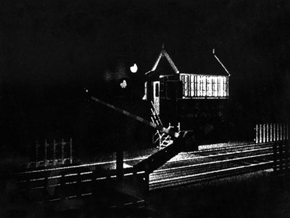 film still: Level crossing: The train that goes past at the level crossing was filmed by me and my brother John in the West Country (my films are always real family affairs). I was disappointed by how short the train was and it didn’t allow me time to mix in all of my London photographs over the scene. So I just looped the passing carriages. I was really chuffed to receive a letter from a train-spotter who saw the film on Channel 4 and said he loved it but was puzzled which railway line had a train with so many carriages!

